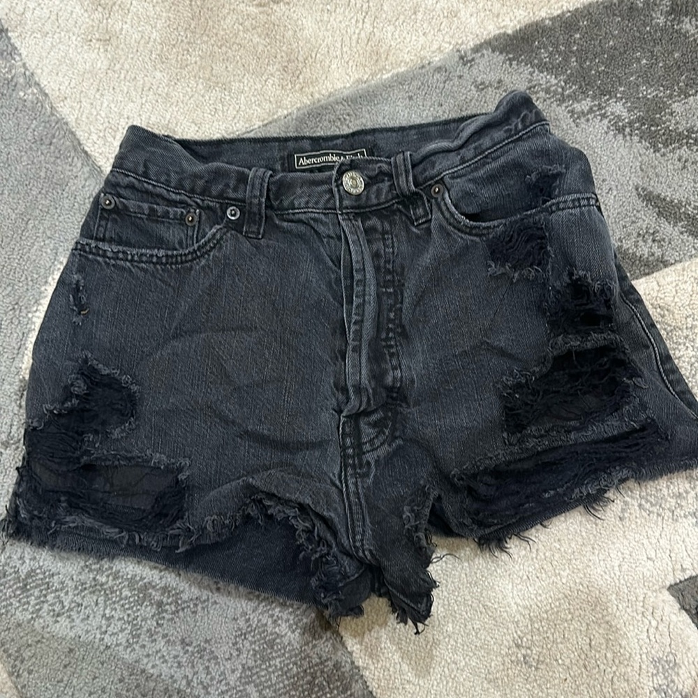 Black ripped shorts with button snaps all the way up